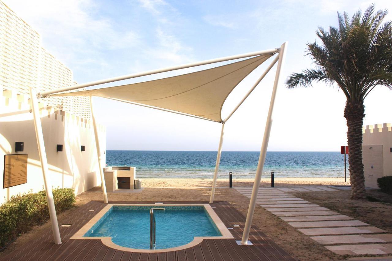 Sealine Beach, A Murwab Resort Месаид Экстерьер фото A shade sail over a swimming pool